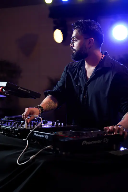 Just AMN, South African DJ based in Dubai, adjusting the mixer during a live set